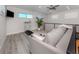 Loft area with hardwood floors, natural lighting, and comfortable seating at 616 Gardenia Dr, Venice, FL 34285