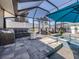 Relaxing outdoor space with a screened-in pool, comfortable seating, and lush landscaping, perfect for entertaining or unwinding at 616 Gardenia Dr, Venice, FL 34285