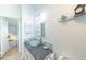 Bathroom featuring a glass bowl sink atop a granite counter, complemented by modern lighting fixtures at 633 White Pine Tree Rd # 27, Venice, FL 34285