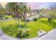 Landscaped exterior featuring mature trees and a well-maintained lawn in a tranquil neighborhood at 633 White Pine Tree Rd # 27, Venice, FL 34285