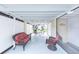 Relaxing screened-in lanai furnished with comfortable seating and ambient string lights at 633 White Pine Tree Rd # 27, Venice, FL 34285