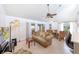 Bright living room featuring tile flooring, a ceiling fan, and sliding door access to the lanai at 633 White Pine Tree Rd # 27, Venice, FL 34285