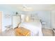 Cozy main bedroom with blue walls, tiled floor, a ceiling fan and abundant natural light from a nearby window at 633 White Pine Tree Rd # 27, Venice, FL 34285