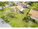 Aerial view of the home's rear exterior, including a lush lawn and mature landscaping at 633 White Pine Tree Rd # 27, Venice, FL 34285