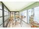 Enclosed sunroom offering multiple windows and sliding glass door access to the home's interior at 633 White Pine Tree Rd # 27, Venice, FL 34285
