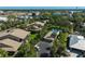 An aerial view of a charming community with a pool surrounded by lush greenery and palm trees at 6724 Schooner Bay Cir # 6724, Sarasota, FL 34231