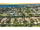 Waterfront homes with boat docks line a canal in this sunny aerial view of a coastal Florida community at 6724 Schooner Bay Cir # 6724, Sarasota, FL 34231