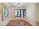 Cozy dining area with bay window and tile flooring, illuminated by modern light fixture at 6724 Schooner Bay Cir # 6724, Sarasota, FL 34231