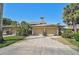 Exterior shot of two-car garage featuring well-maintained landscaping and concrete driveway at 6724 Schooner Bay Cir # 6724, Sarasota, FL 34231
