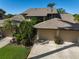 Exterior of the home highlighting a well-maintained driveway, two-car garage, and tropical landscaping at 6724 Schooner Bay Cir # 6724, Sarasota, FL 34231