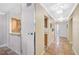 Hallway with tile flooring, decorative lighting, and a glimpse into the kitchen at 6724 Schooner Bay Cir # 6724, Sarasota, FL 34231