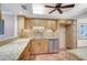 Traditional kitchen features granite countertops, tile flooring, wood cabinets, and stainless steel appliances at 6724 Schooner Bay Cir # 6724, Sarasota, FL 34231