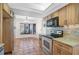 Efficient kitchen with stainless steel appliances, granite countertops, and tile backsplash and flooring at 6724 Schooner Bay Cir # 6724, Sarasota, FL 34231