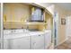 Bright laundry room with washer, dryer, water heater and shelving at 6724 Schooner Bay Cir # 6724, Sarasota, FL 34231