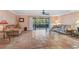 Bright living area with expansive tile flooring, neutral walls, and a seamless flow to outdoor screened patio at 6724 Schooner Bay Cir # 6724, Sarasota, FL 34231