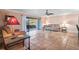 Comfortable living room with neutral walls, ceiling fan, and glass sliding doors to lanai offering natural light at 6724 Schooner Bay Cir # 6724, Sarasota, FL 34231