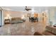 Open-concept living space with tile floors, connecting the living room, dining area, and kitchen at 6724 Schooner Bay Cir # 6724, Sarasota, FL 34231