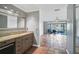 Main bathroom features granite countertop vanity, tile flooring and access to lanai at 6724 Schooner Bay Cir # 6724, Sarasota, FL 34231
