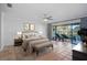 Spacious main bedroom with tile flooring, access to lanai, and relaxing lounge chairs at 6724 Schooner Bay Cir # 6724, Sarasota, FL 34231
