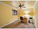 Functional office space with neutral carpet, wooden desk, and ceiling fan at 6724 Schooner Bay Cir # 6724, Sarasota, FL 34231