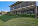 Screened patio showcasing a spacious outdoor living area with serene views of the lush green lawn at 6724 Schooner Bay Cir # 6724, Sarasota, FL 34231