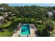 Aerial view of community pool, surrounded by lush greenery and lounge chairs for relaxation at 6724 Schooner Bay Cir # 6724, Sarasota, FL 34231