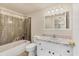 Bathroom with shower and tub combination, along with a vanity with marble countertop at 680 Circlewood Dr # W3, Venice, FL 34293
