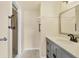 Updated bathroom features modern vanity with storage, and tiled walk-in shower at 680 Circlewood Dr # W3, Venice, FL 34293