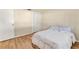 Bedroom with wood-look flooring features a closet and a ceiling light at 680 Circlewood Dr # W3, Venice, FL 34293