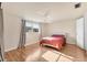 Cozy bedroom featuring wood flooring, natural light, and a ceiling fan at 680 Circlewood Dr # W3, Venice, FL 34293