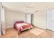 Bright bedroom features a ceiling fan, wood-look flooring, and ensuite access at 680 Circlewood Dr # W3, Venice, FL 34293