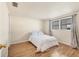 Cozy bedroom with wood-look flooring and natural light from a large window at 680 Circlewood Dr # W3, Venice, FL 34293