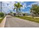 Inviting entrance to the neighborhood with manicured landscaping and a secure gate at 680 Circlewood Dr # W3, Venice, FL 34293