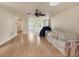 Spacious living room featuring hardwood floors, a ceiling fan, and natural light at 680 Circlewood Dr # W3, Venice, FL 34293