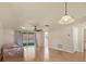 Spacious living area with hardwood floors, sliding glass doors, and a ceiling fan at 680 Circlewood Dr # W3, Venice, FL 34293
