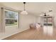 Bright living room with hardwood floors, large windows, and sliding glass door at 680 Circlewood Dr # W3, Venice, FL 34293