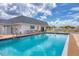Community pool featuring clear blue water and lounge chairs against a partly cloudy sky at 680 Circlewood Dr # W3, Venice, FL 34293