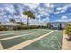 Community shuffleboard courts featuring a blue roof building and partly cloudy skies at 680 Circlewood Dr # W3, Venice, FL 34293