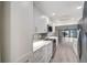 Modern kitchen featuring stainless steel appliances, stone countertops, and beautiful backsplash at 700 Golden Beach Blvd # 115, Venice, FL 34285