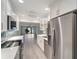 Bright kitchen featuring stainless steel appliances, quartz counters, and open layout at 700 Golden Beach Blvd # 115, Venice, FL 34285