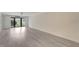 Open living room features plenty of natural light and sliding glass doors to the balcony at 700 Golden Beach Blvd # 115, Venice, FL 34285