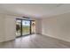 Cozy living room with balcony access, providing views of the waterfront at 700 Golden Beach Blvd # 115, Venice, FL 34285
