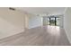 Spacious living room with neutral paint and hardwood flooring, flooded with natural light at 700 Golden Beach Blvd # 115, Venice, FL 34285