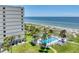 Enjoy a sparkling community pool steps from the beach, with palm trees and ocean views at 700 Golden Beach Blvd # 115, Venice, FL 34285