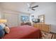 This lovely bedroom includes a ceiling fan, wood floors, and a comfy bed at 726 Bird Bay W Dr # 153, Venice, FL 34285