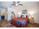 Cozy bedroom featuring wood floors, ceiling fan, and two bedside tables at 726 Bird Bay W Dr # 153, Venice, FL 34285