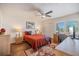 Bright bedroom features a ceiling fan, wood floors, and a decorative rug at 726 Bird Bay W Dr # 153, Venice, FL 34285