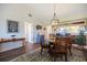Cozy dining area with open floor plan, stylish chandelier, and easy access to kitchen at 726 Bird Bay W Dr # 153, Venice, FL 34285