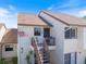 Charming two-story condo with stairs leading to the front door and an American flag at 726 Bird Bay W Dr # 153, Venice, FL 34285