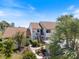 Inviting two-story condo with tropical landscaping, offering a serene and picturesque curb appeal at 726 Bird Bay W Dr # 153, Venice, FL 34285